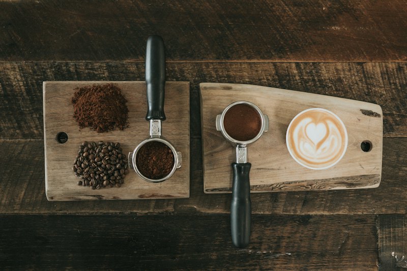 Sample photo: espresso, coffee beans and a portafilter on dark wood