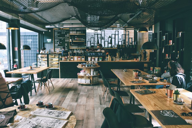 Sample photo: a bright café dining room with wooden tables